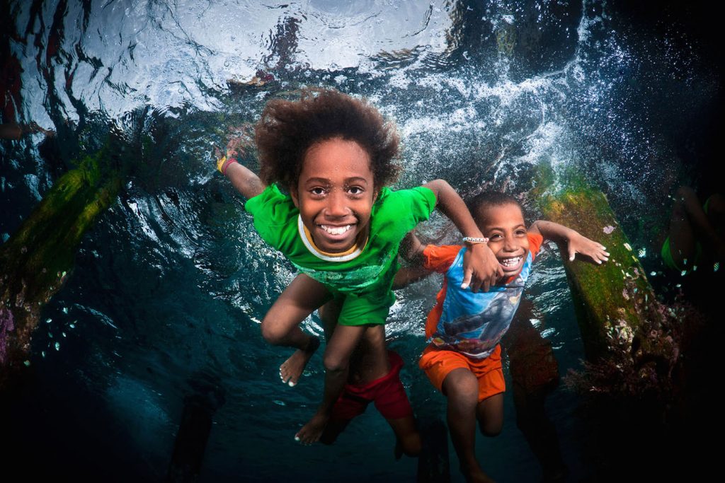 Local village Kids diving, Raja Ampat, West Papua, Indonesia