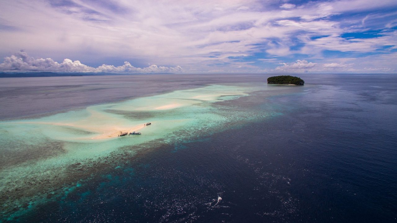 panoramic view of a sandbank and island used for diving breaks near Papua Explorers Resort