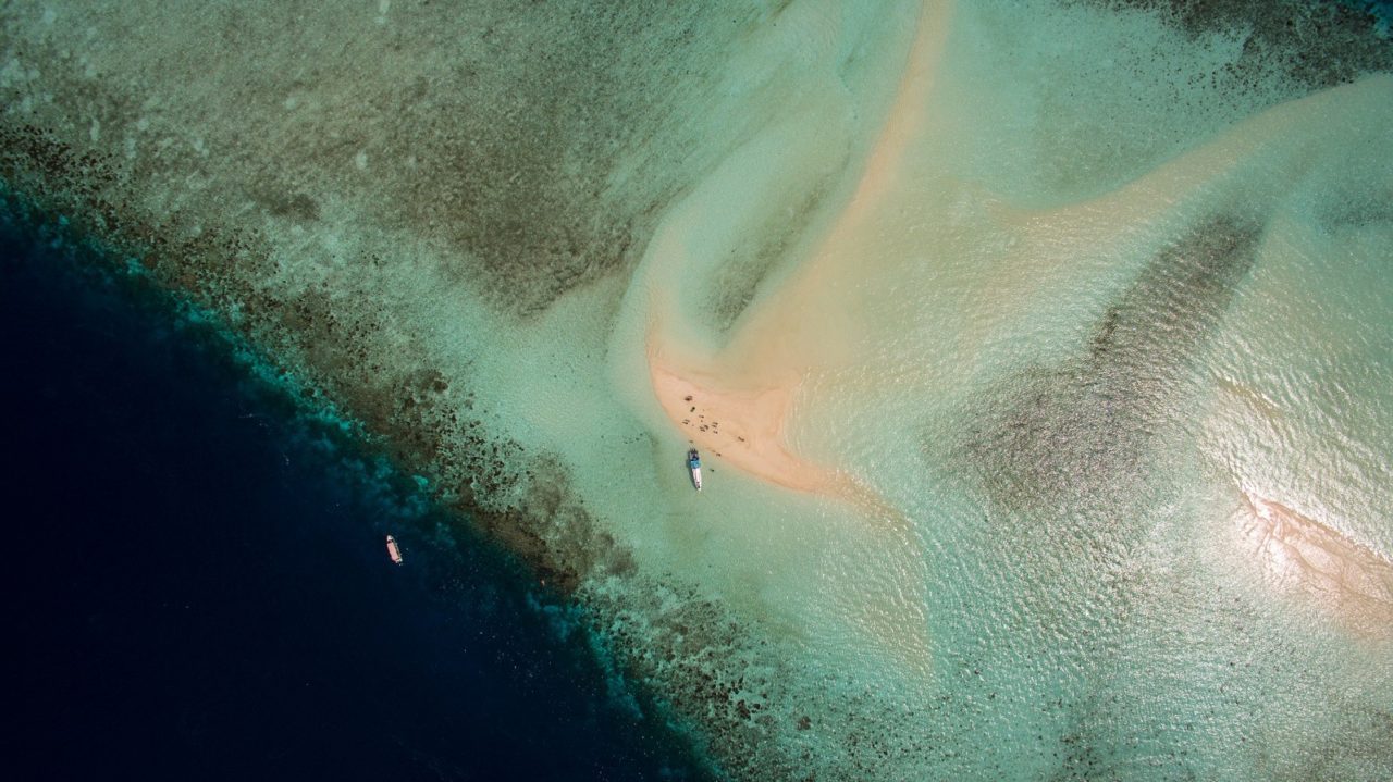 (English) Aerial of a sandbank often used for diving breaks near Papua Explorers Resort