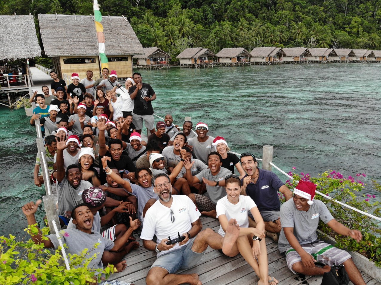 group photo of our employees and managers at our dive resort in Raja Ampat