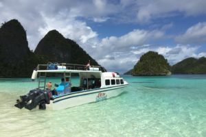 our Papua Explorers boat at a secluded beach in the wayag islands in raja ampat
