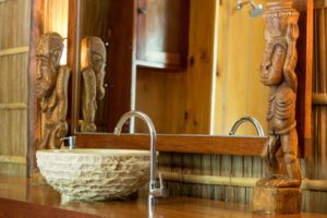 raja ampat overwater bungalows washbasin, mirror and decoration in the bathroom