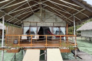sun rising below the roof of a bungalow