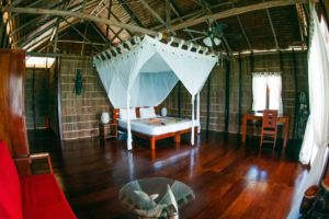 the bed inside one of our spacious raja ampat overwater bungalows