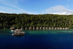 aerial view of the Papua Explorers resort layout showing the dive centre, jetty and water bungalows in the background