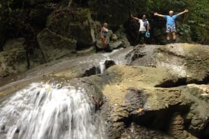 guests and guide hiking up the river on Batanta island in Raja Ampat