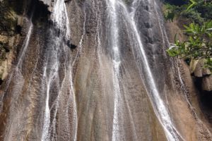 (English) full view of a beautiful waterfall on Batanta island in Raja Ampat which we visit on one of our Papua Explorers daytrips