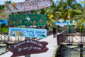 signs on the jetty of Arborek not far from Papua Explorers Dive Resort reminding to treat the environment with care