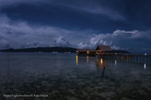 (English) evening sky brightened by the moon with our Raja Ampat dive centre and spa below