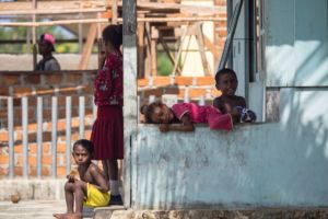 four local Papuan kids on the porch of their house in Yenwaupnor close to Papua Explorers Dive Resort