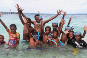 village kids of Raja Ampat in the water while snorkeling