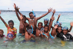 village kids of Raja Ampat in the water while snorkeling